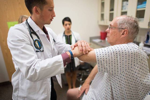 Students working with a standardized patient